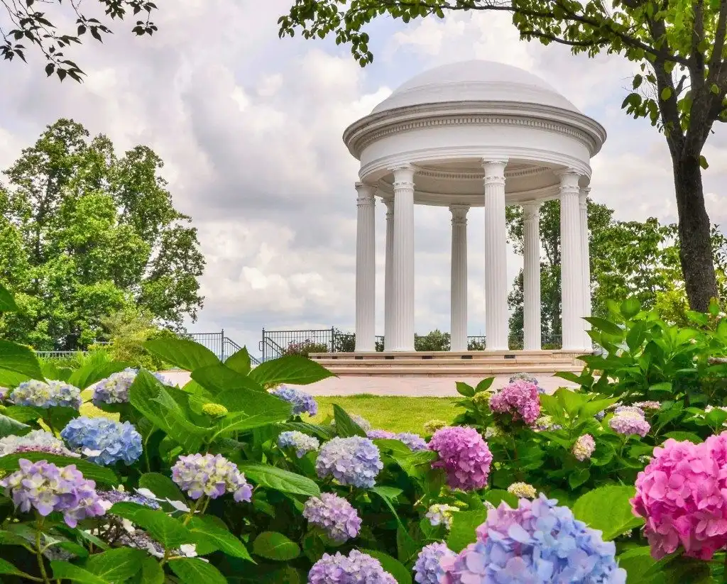 Sibyl Temple rotunda surrounded by blooming hydrangeas at Jemison Park in Mountain Brook AL
